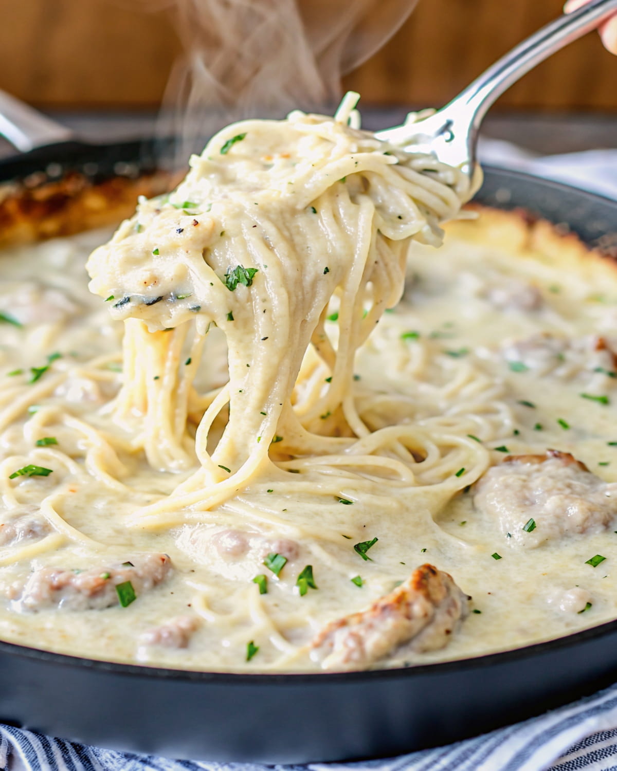 Spaghetti squash chicken alfredo meal prep with tender chicken pieces, rich white sauce, and melted cheese pulled with a fork.
