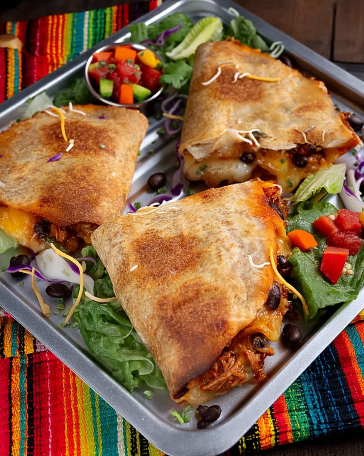 Quesadilla meal prep with crispy golden tortillas filled with melted cheese, black beans, and meat.