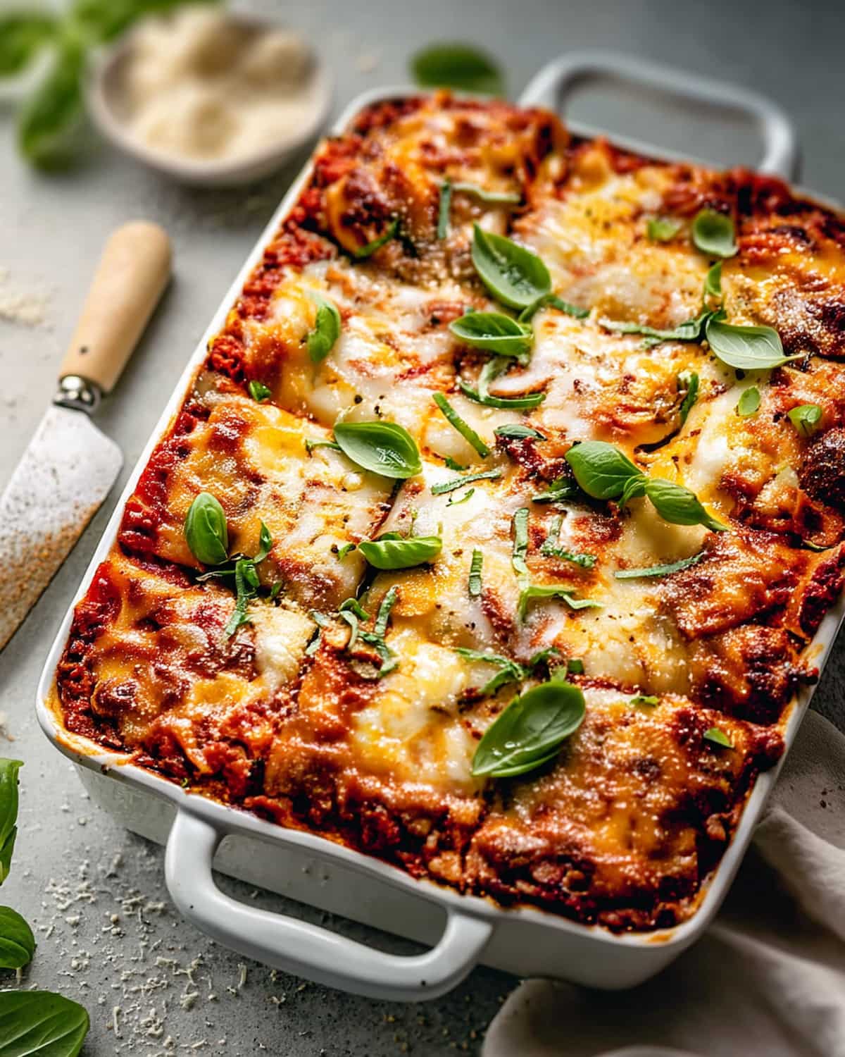 Ground Turkey Lasagna Meal Prep baked in a white dish with layers of turkey, marinara, melted cheese.