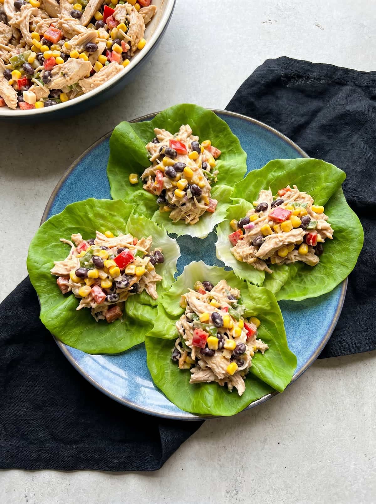 Chicken Taco Salad Meal Prep with shredded chicken, black beans, corn, and peppers served in crisp.